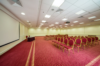 acoustic ceiling installed in empty conference hall with red carpet for hotel building