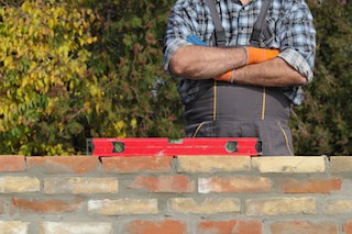 general contractor inspects quality of work and if brick wall is level