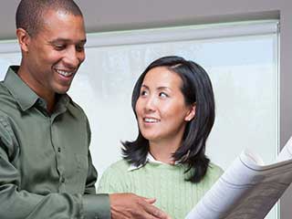 couple studying plans for starting an assisted living facility