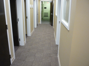 dental office renovation hallway with paint, floor coverings, doors and ceilings