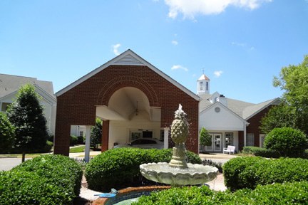 virginia retirement home remodel drive up entryway with garden fountain